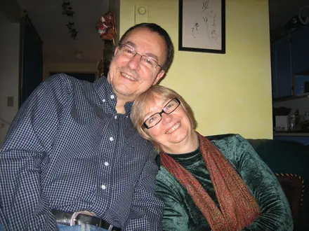 Robert leaning his head against his sister Jackie&rsquo;s, both smiling, in a warm yellow room.